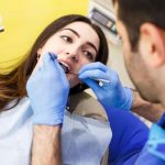 dentist performing tooth extraction