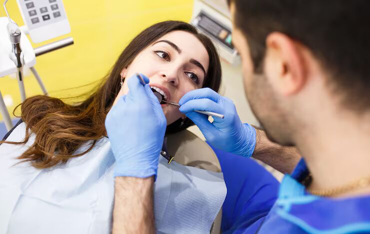 dentist performing tooth extraction